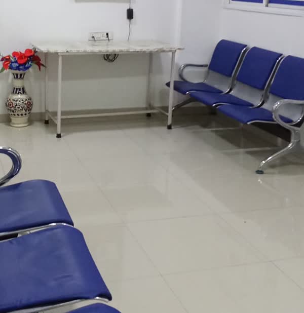 Waiting area with rows of blue chairs